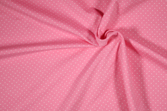 Rosa Stoff mit kleinen weißen Punkten – klassisch & süß.