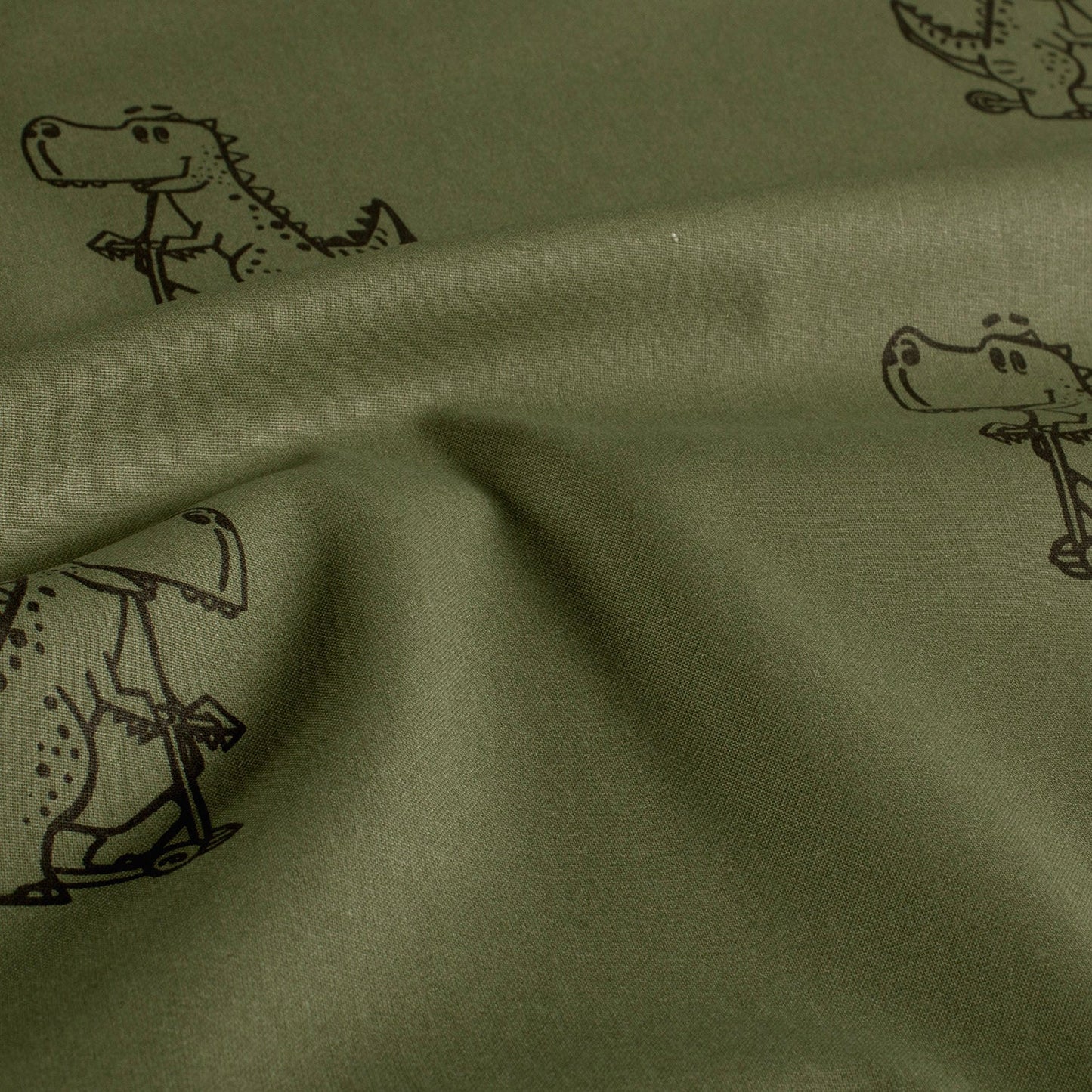 Baumwoll-Popeline Dinosaurier Dunkelgrün – Stoffansicht