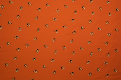 Oranger Baumwolljersey mit kleinen Hundemotiven – 140 cm breit