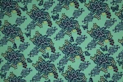 Verspielter Baumwollstoff mit floralen Ornamenten auf Mint.