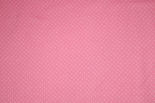 Zartes Punktmuster auf rosa Baumwollstoff – ideal für Baby- und Kinderkleidung.