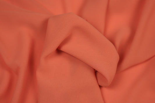 Detailaufnahme von Chiffonstoff in Koralle – halbtransparent und edel fallend
